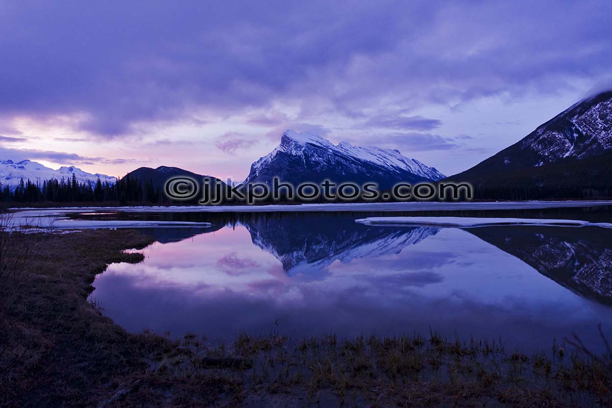 Mountain reflected in a still dawn lake